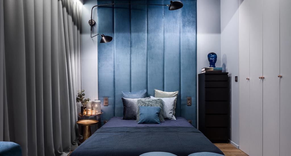 Blue upholstered bedroom wall